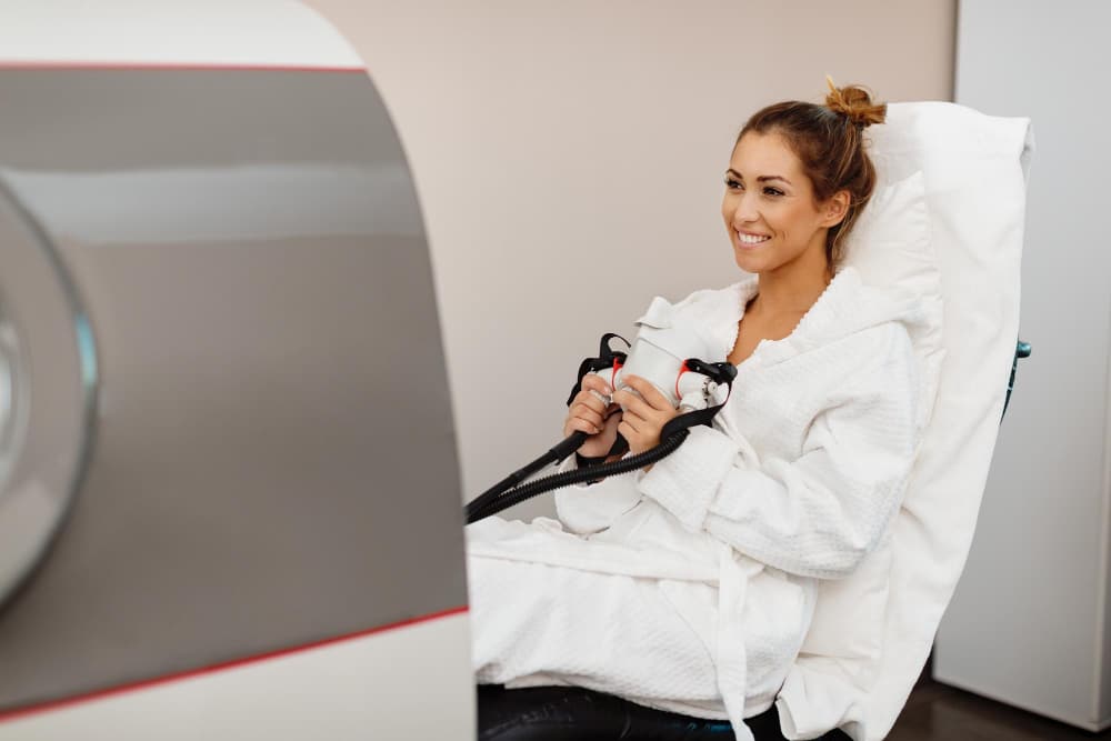 happy woman receiving oxygen therapy hyperbaric chamber health spa