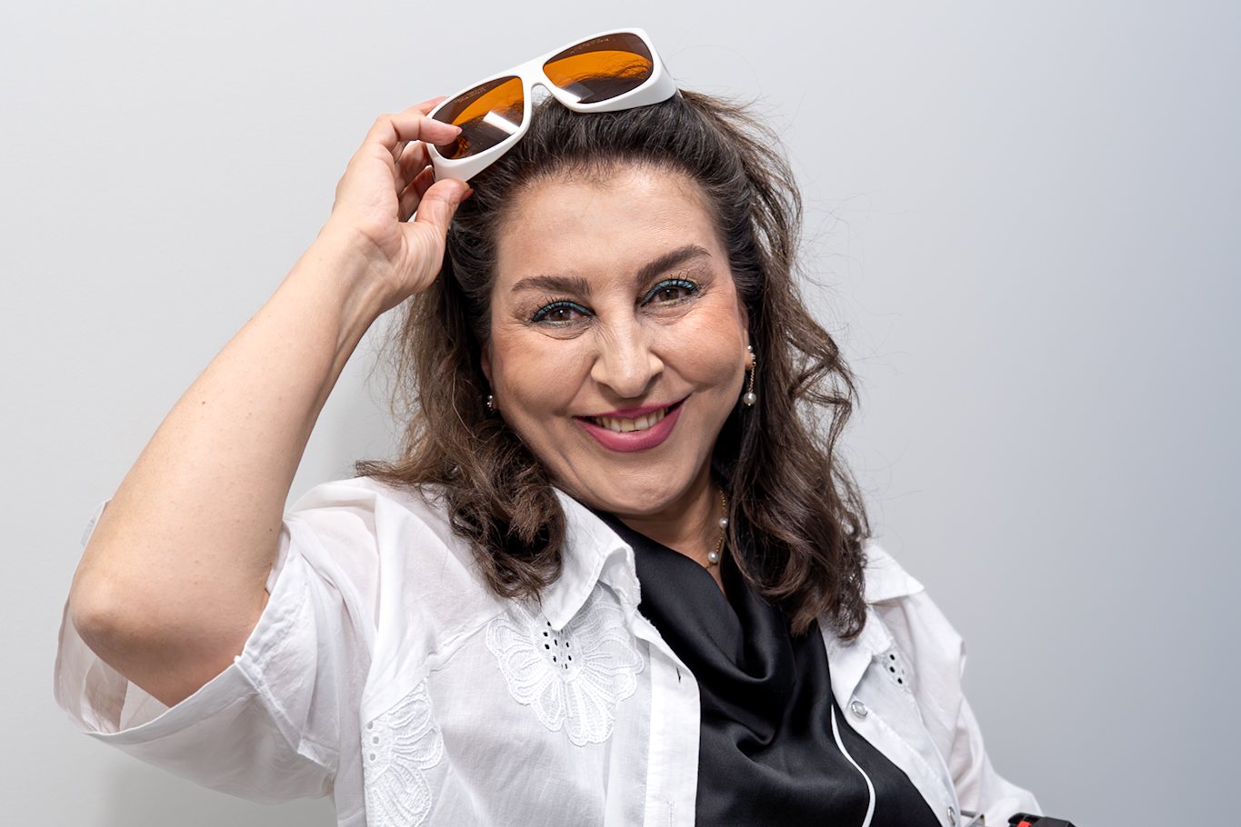 Foroozan Saneie, laser hair removal practitioner, holding the Elite iQ handpiece at 4D Skin Care Clinic in North Vancouver